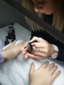 Fanny preparing the nail for a gel polish manicure